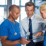 Medical team interacting using digital tablet at modern hospital
