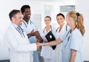A group of nurses and doctors smiling and talking