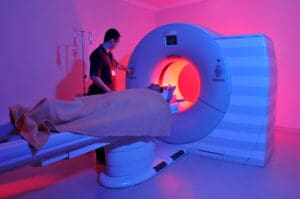 A patient being helped into an MRI machine