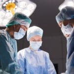 surgery, medicine and people concept – group of surgeons at oper