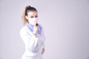Nurse holding her hand up in a hush gesture