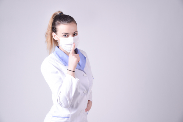 Nurse holding her hand up in a hush gesture