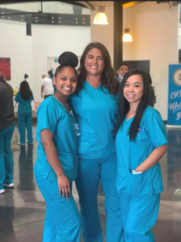 Three CNI College nursing students standing together