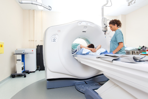 MRI Technician preparing patient for MRI scan test in hospital room