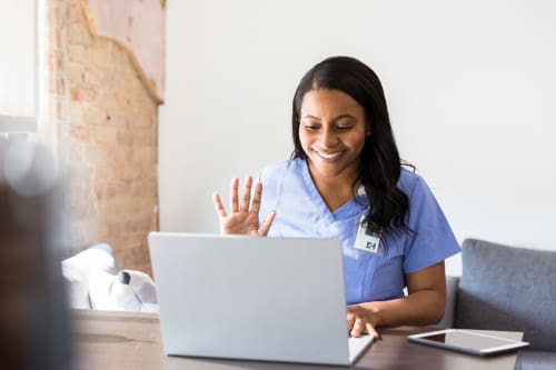A nurse on a laptop doing a telehealth visit