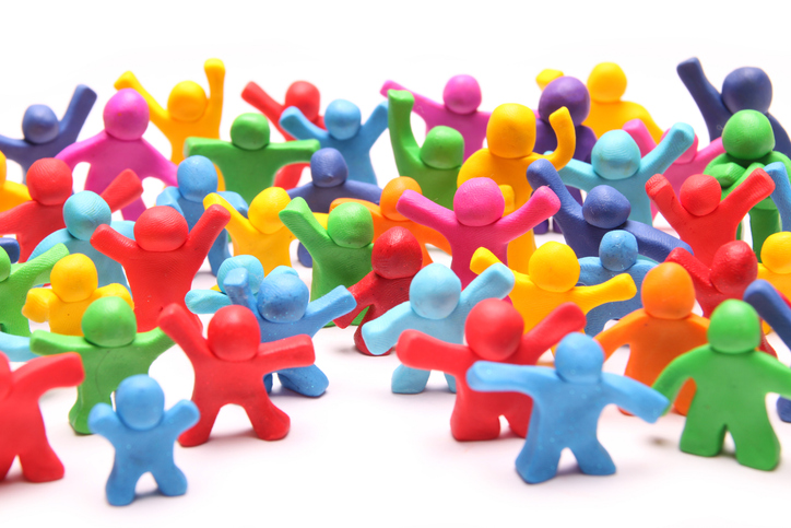 A group of multi-color-clay figures standing with their arms raised