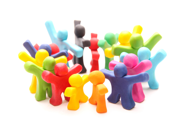 A group of multi-color clay figures standing in a circle
