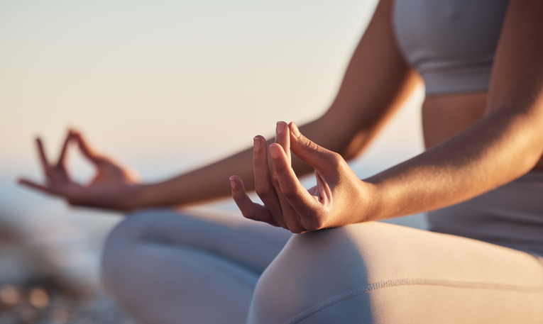 I woman sitting cross-legged with mudra hands