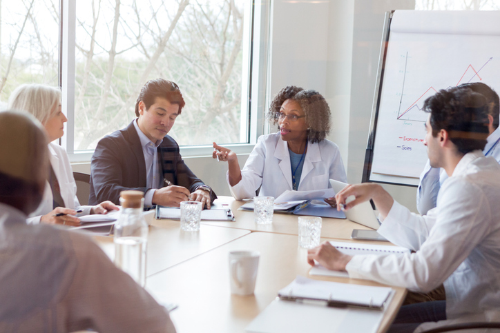 A group of hospital leadership in a conference room