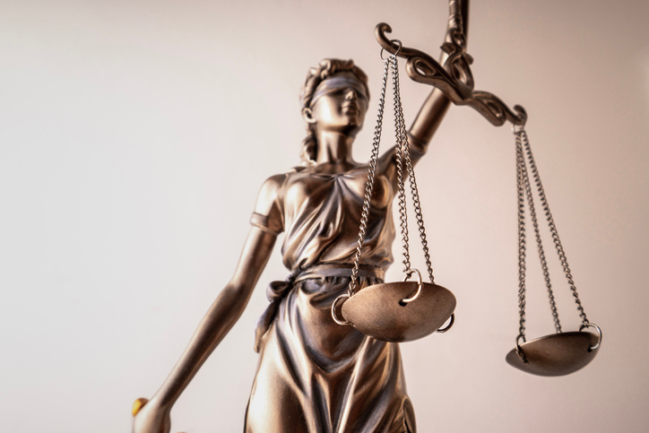A metal statue of the scales of justice