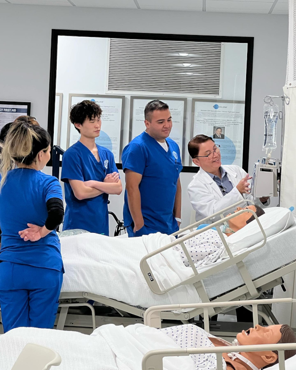 Nursing students and an instructor working with a mannequin
