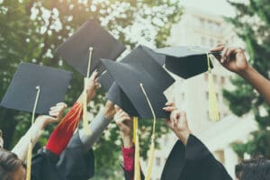 Students holding graduation caps