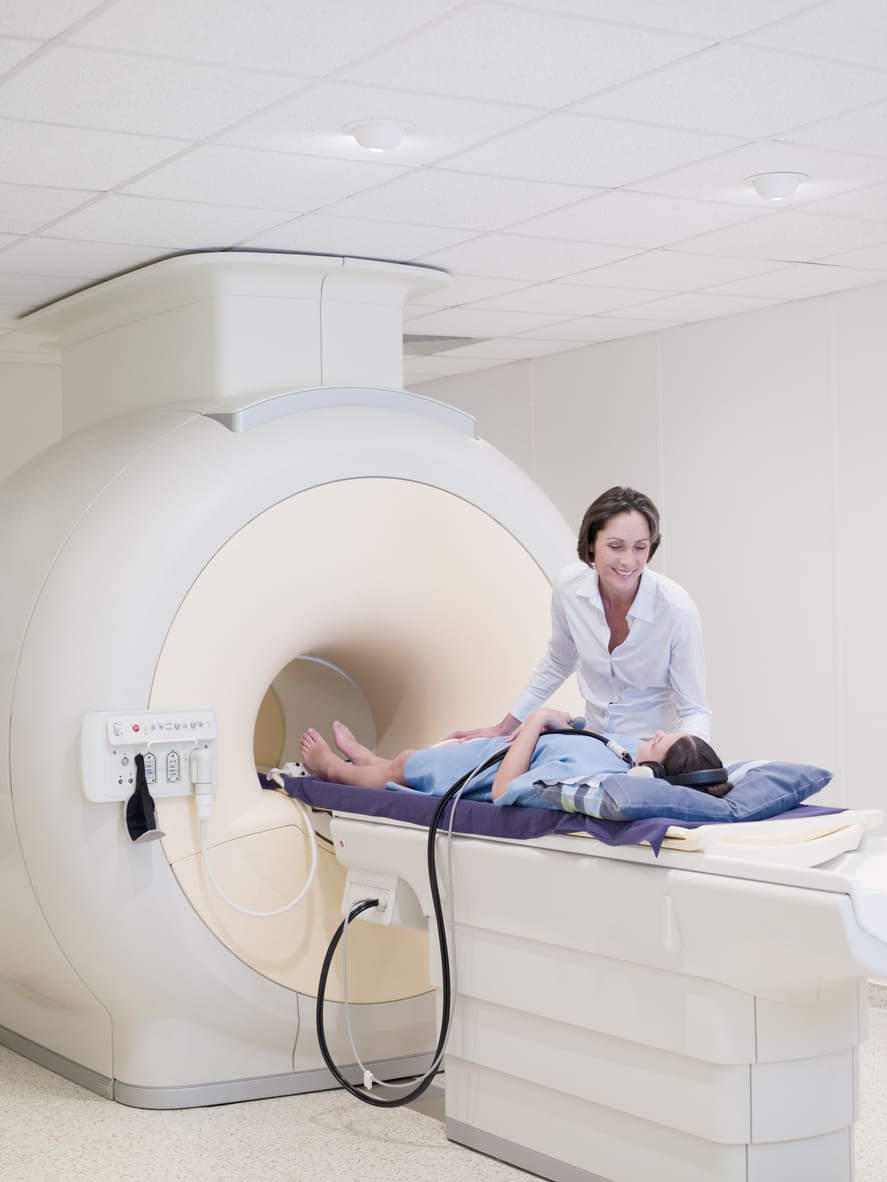 An MRI tech helping a patient